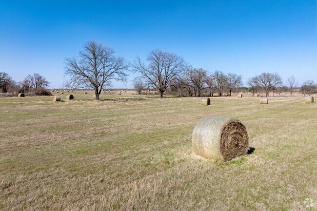 Hay barrels fill the land in Stephenville, showcasing the area's agricultural roots.