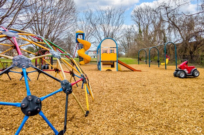 South Four Corners Park provides shaded green space for family activities.