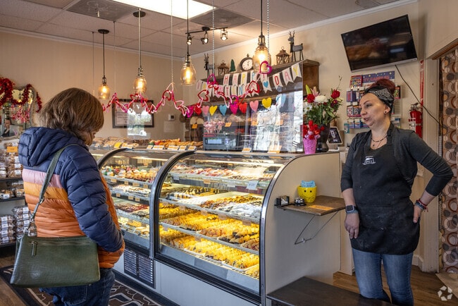 Bridgewater Bakery's owner chats about a hazelnut loaf with a customer in Finderne.
