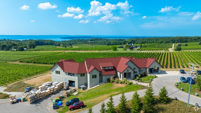 Brys Estate’s red-roofed winery overlooks vineyard rows and Grand Traverse Bay in Michigan.