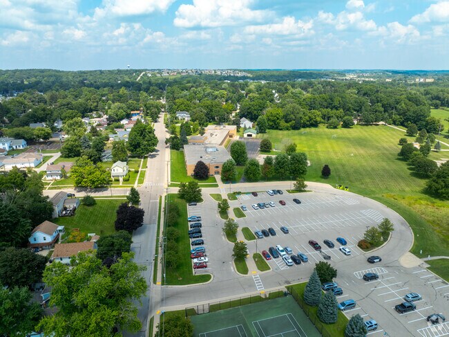 Eastview Elementary School parking lot and athletic facilities on a sunny day in Lake Geneva.