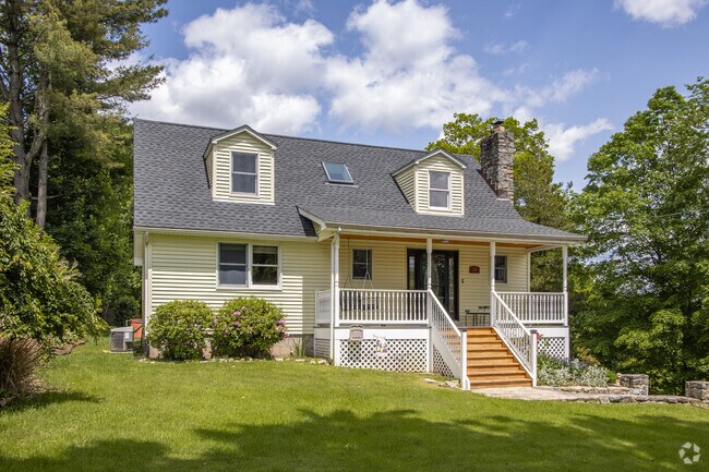 Many homes in Lake Carmel sit on larger wooded lots, where backyards open into gardens, tall grass, and long afternoons.