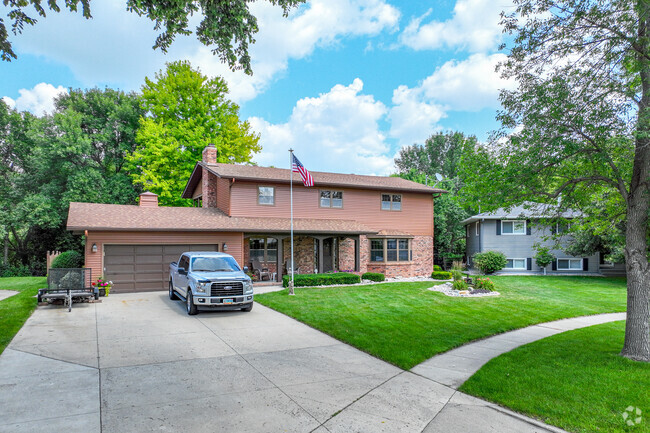 You will find larger homes in River West with bright green grass.