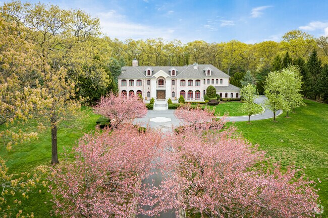 Beautiful flowering trees line the driveway of this Upper Brookville mansion.