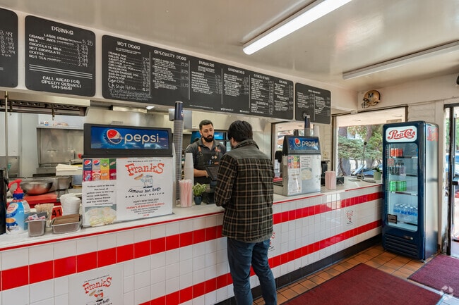 A patron orders his lunch at Frank's Famous Hot Dogs.