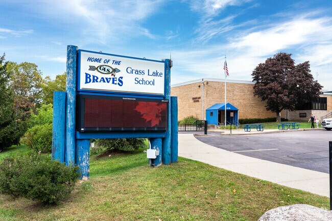 A parent picks up their child from Grass Lake school.