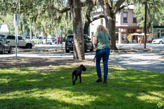 Residents walk their dogs around the well-maintained Thomas Square Park.