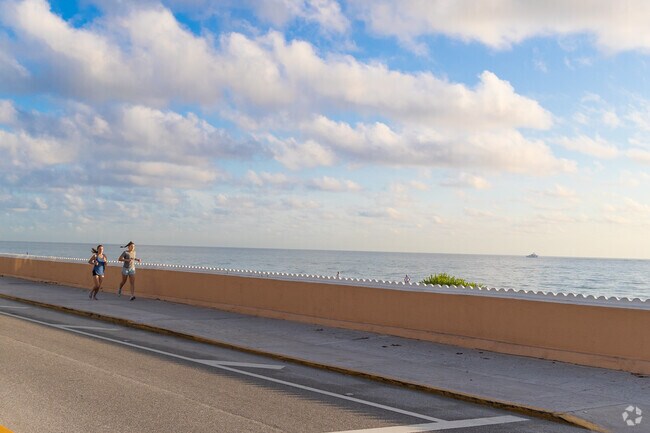 Palm Beach residents enjoy the cool ocean breeze on a morning run.
