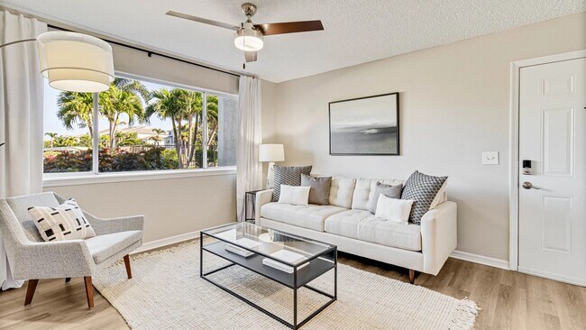 Spacious living area with connecting dining and kitchen areas.
