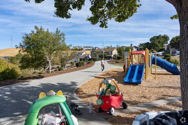 Families socialize at the playground of Oak Hills Park.