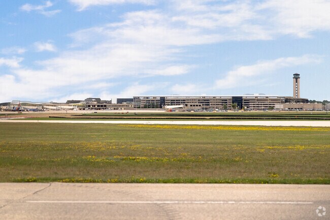 A view of Milwaukee Mitchell International Airport under a blue sky.