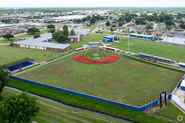 The baseball team at St. Charles Catholic High School practices on the field.