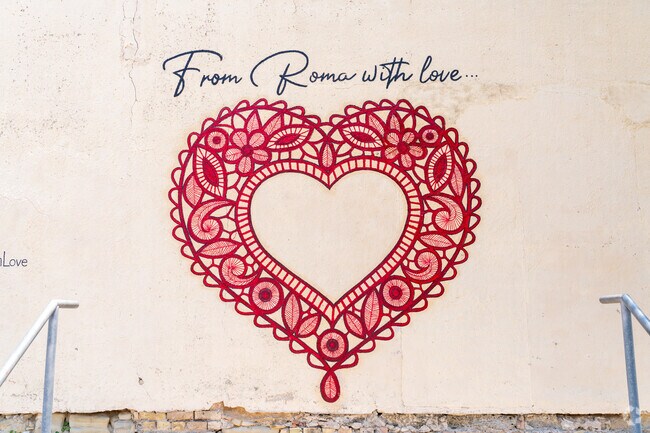 Bright red heart mural is a popular photo spot when visiting the city of Roma