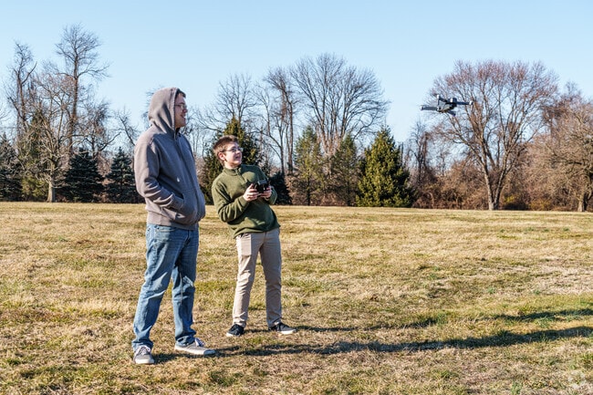 A couple of Claymont boys toy with their drone at Woods Haven Kruse Park.