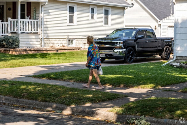 Haevers Corner residents take advantage of shaded sidewalks.