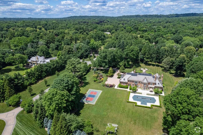 Old Westbury is home to many sprawling estates surrounded by lush green vegetation.