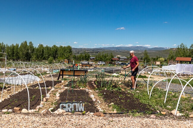 A man cares for the community garden at Knoop Memorial Park.