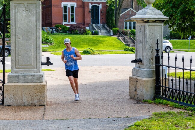 A jogger runs through the entrance of Lafayette Park.