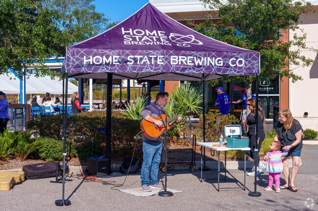 A Horizon West performer serenades a young fan at the local farmers market.