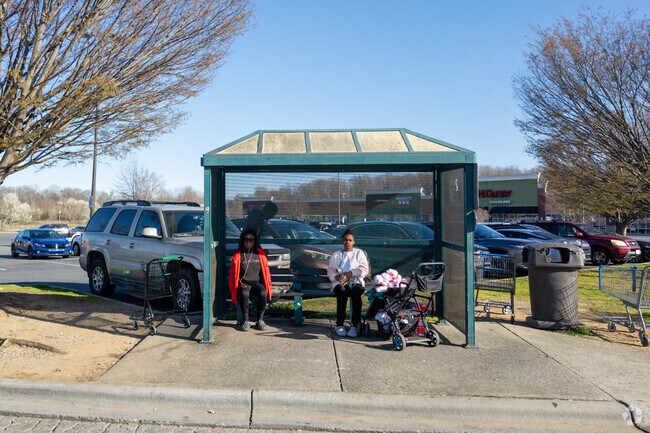 Phillips Ave's lifeline: Commuters wait at the bus stop.