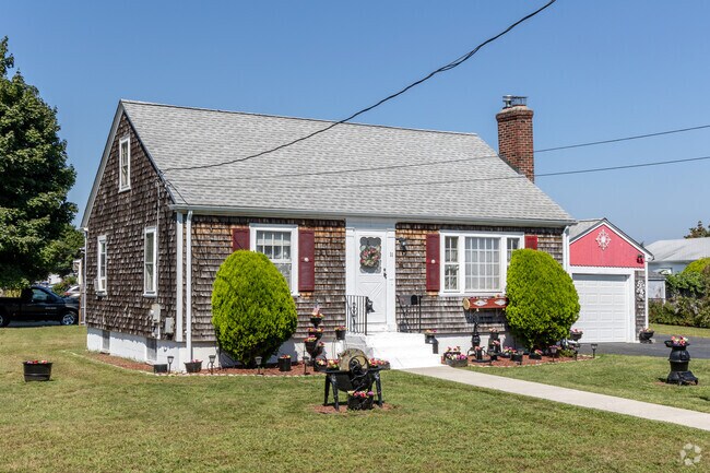 Shingle siding and cozy vibes make this Hillsgrove cottage a New England classic.