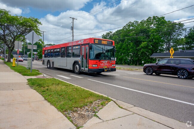 A busy Metro bus passes Oakwood Plaza, connecting residents to Kalamazoo.