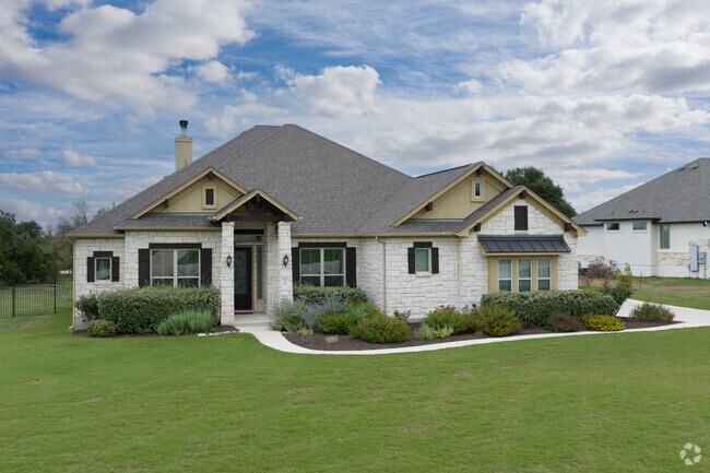 Stone facade two-story homes line the quiet streets of Butler Farms in Liberty Hill.