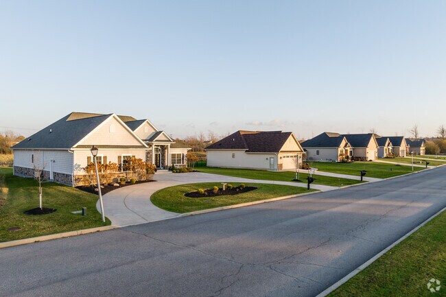 Row homes in Harris Hill feature large driveways, including a semi-circular one.