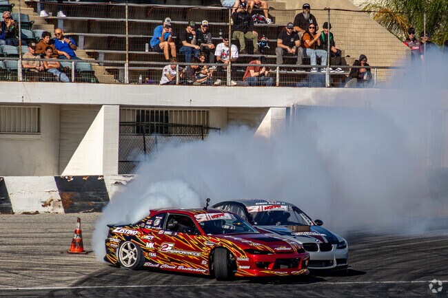 Drifters battle on the racetrack at Hotpit Autofest In San Bernardino.