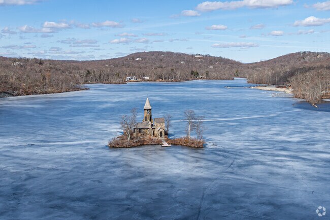St. Hubert’s Chapel, a historic stone chapel located on an island in Lake Kinnelon, is known for its stained glass windows, which are believed to have been crafted by Tiffany Studios.