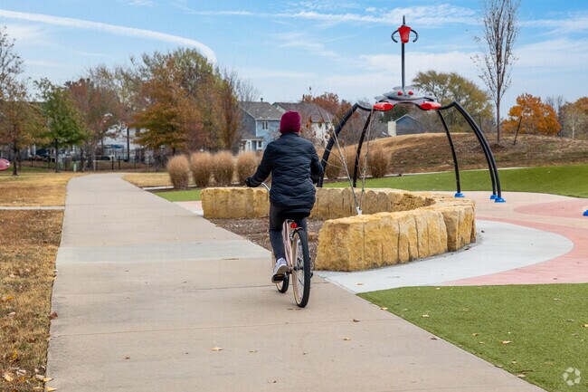 Locals enjoy an afternoon bike ride through the paths at Harrison Park.