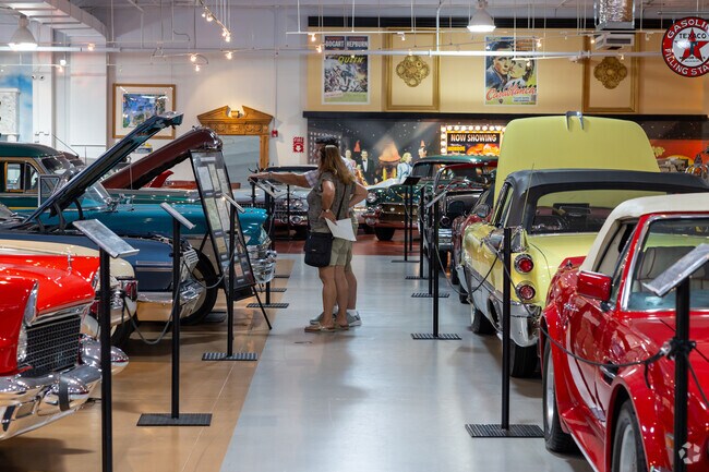 Visitors admire restored classic cars at Dauer Car Museum.