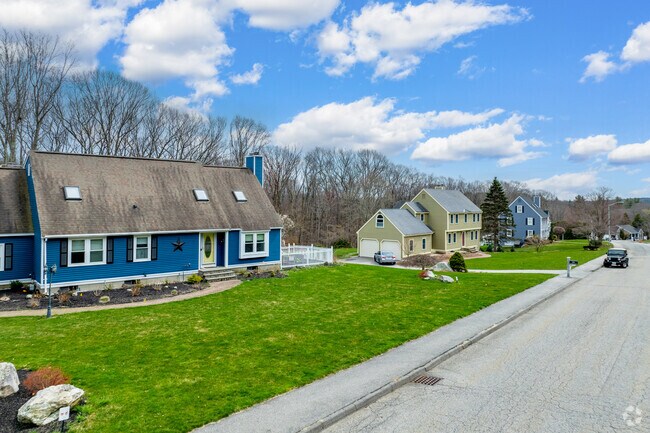 A row of homes in Marlborough sit on a quiet cul-de-sac with trees in their backyards.