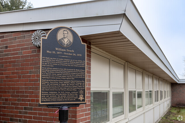 An informative plaque rests at the entrance of William Seach Primary School in Weymouth.