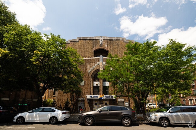 The stunning architecture of P.S. 280Q in Queens, New York peeks from behind neighborhood trees.