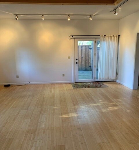 Living space, bamboo flooring, french doors lead to private patio