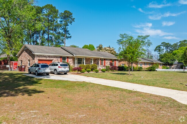 Brick ranch homes in Kings Grant are nestled under mature trees.