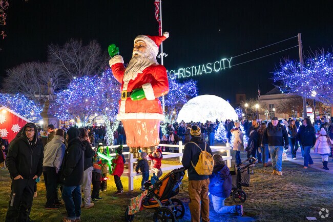 Kids can't help but to run to the huge Santa statue on the Taunton Green.