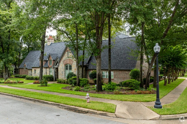 A large Tudor style home sits elegantly on a corner lot in Tyler.