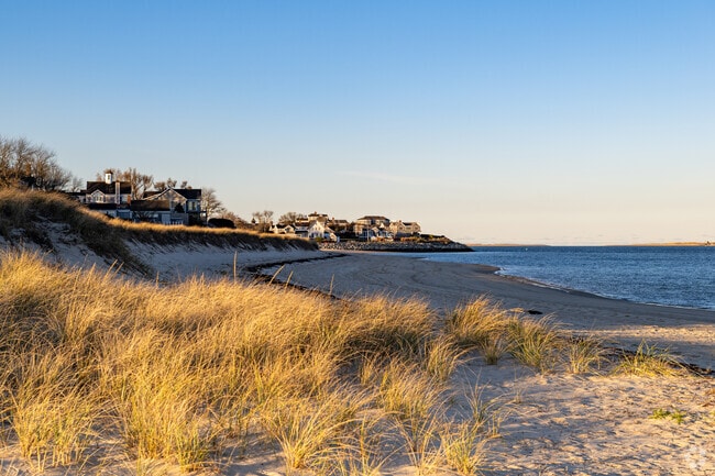 Sandy dunes frame the shoreline of Light House Beach just off Main Street in Chatham Village.