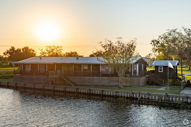 Homes along the bayou of Montegut bask in a golden glow.