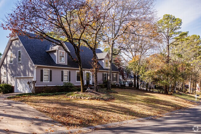 Homes in Crystal Hill sit beneath the cover of large, mature trees.
