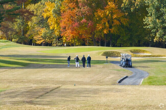 Golfers enjoy scenic fairways at Queenstown Harbor Golf Links.