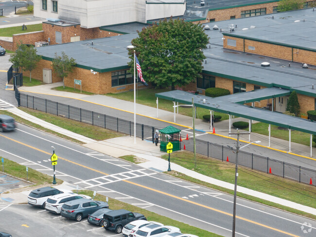 Nathaniel Woodhull Elementary School has a security gate and guard in front of the main entrance