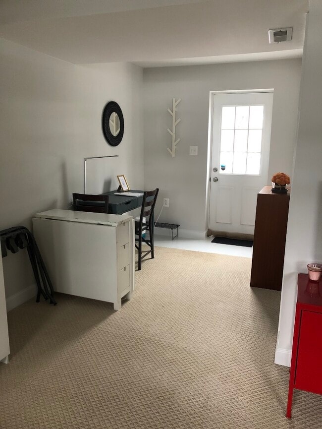 Private entrance from the backyard, desk area with bookshelf.