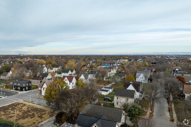 An aerial shot of Metcalf Park captures the neighborhood's tree-lined streets.