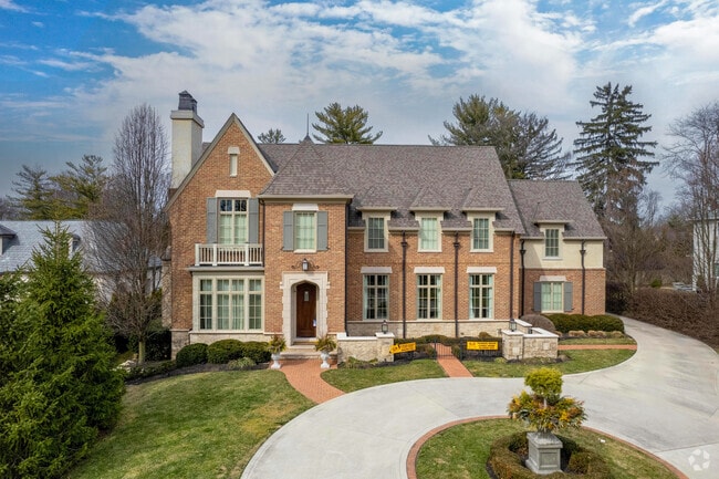 A brick, two-story home in Upper Arlington features an elegant turn-around driveway.