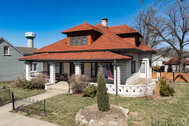 Stucco walls and red tile roof give this bungalow its Spanish-inspired charm in Waterloo IL.