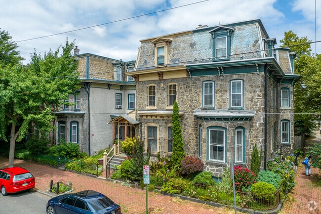 Stone second empire homes sit next to Greek revivals in Powelton Village.