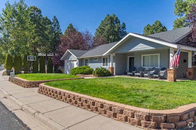 Other Walnut Meadow homes have manicured lawns along walkways of concrete or stone.